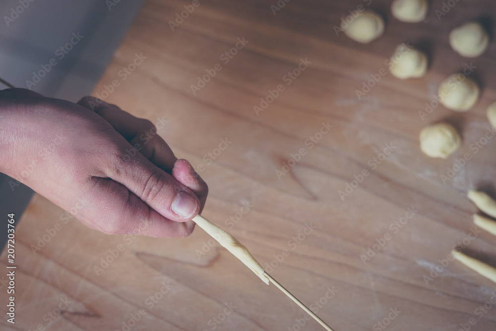 Process of production of pasta. woman hands make fresh pasta on wood board kitchen table Process of production of pasta. woman hands make fresh pasta on wood board kitchen table