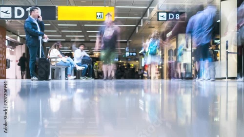 Busy airport transit hall crowds of people moving time lapse