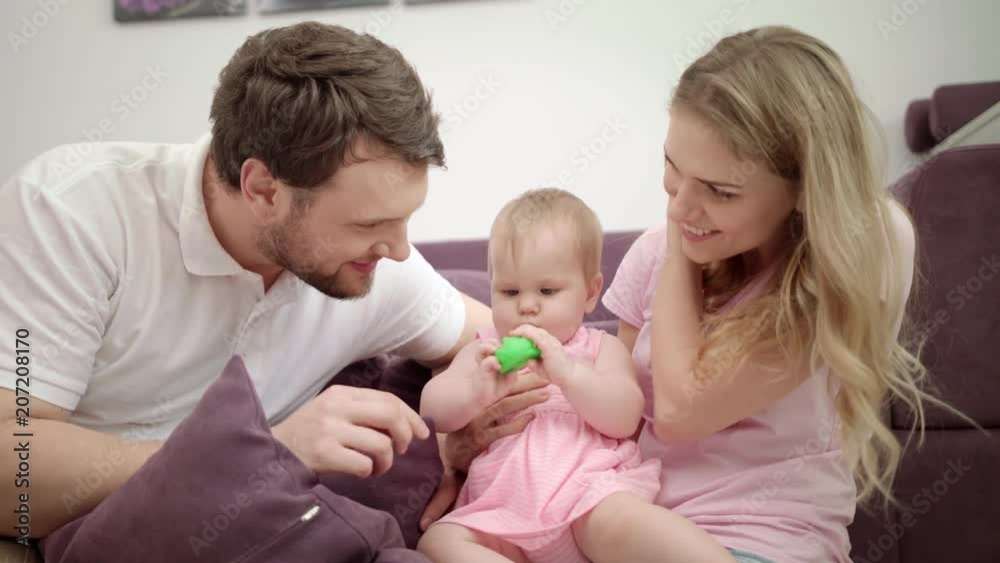 Happy family playing together. Mother and father play with child at home. Togetherness love concept. Joyful family with baby embrace. Enjoy together time. Sweet parenting Happy family playing together. Mother and father play with child at home. Togetherness love concept. Joyful family with baby embrace. Enjoy together time. Sweet parenting