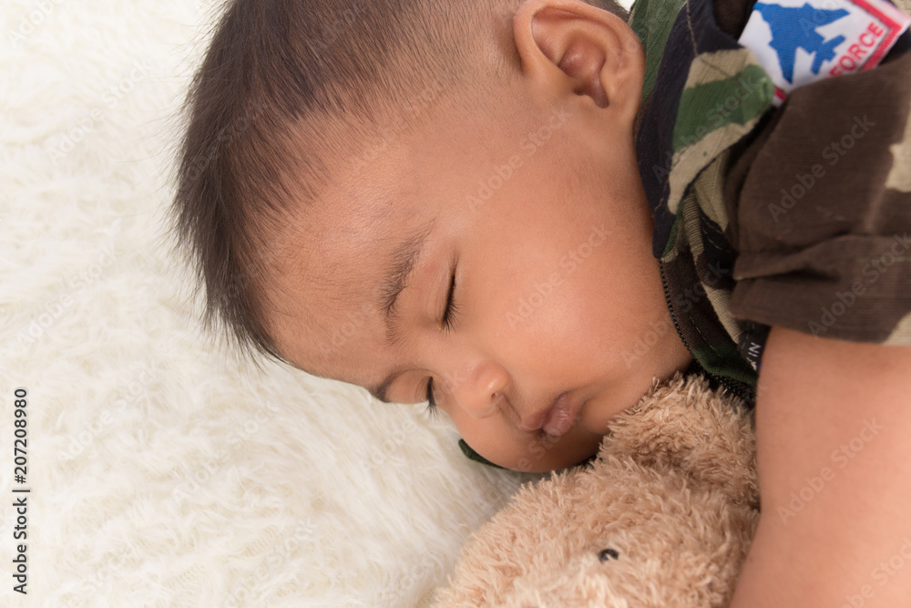 Cute little baby soldier in uniform sleeping Cute little baby soldier in uniform sleeping