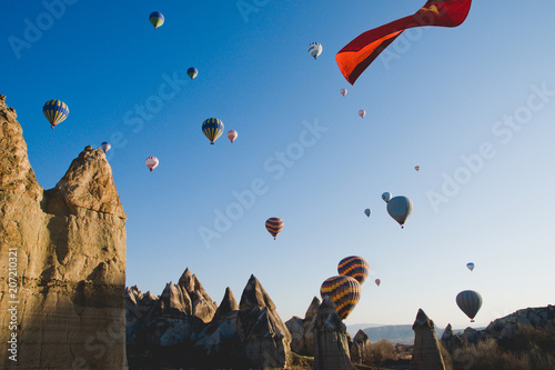 Colorful balloons flying over mountains and with blue sky