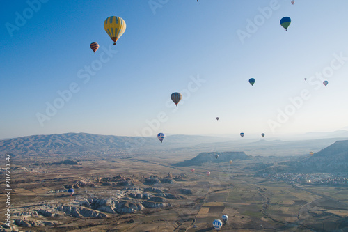 Colorful balloons flying over mountains and with blue sky