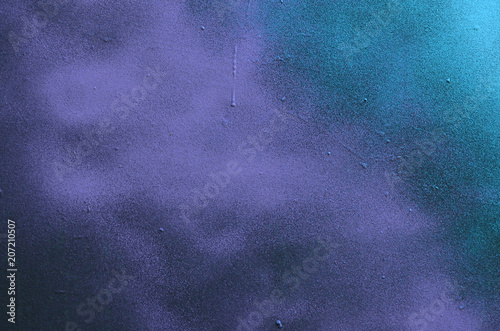 Street art. Abstract background image of a fragment of a colored graffiti painting in cosmic blue and violet tones