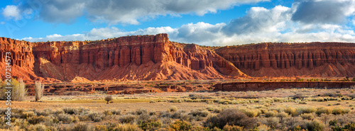 American Southwest Desert Landscape. Classic eroded Navaho sandstone bluffs and blue skies bring up an image of the old west. This is especially true here in Torrey, Utah, near Capitol Reef Park. photo