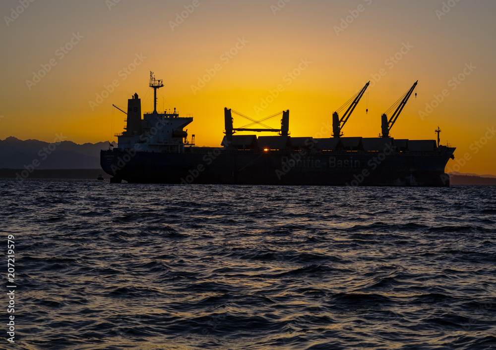 Cargo ship Sunset water and mountains 