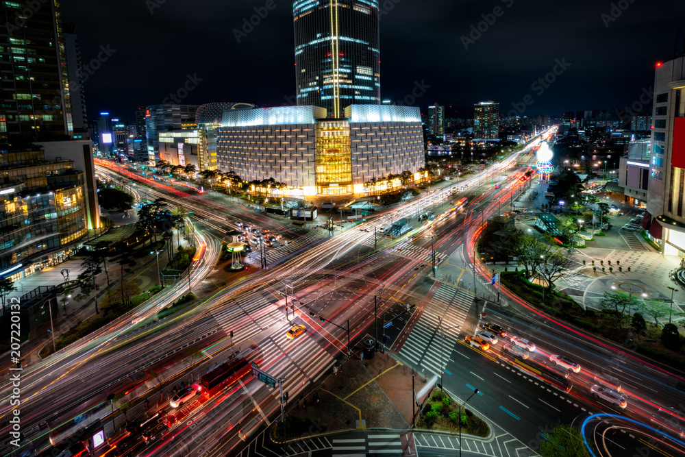 Night scene of light trails traffic speeds through an intersection in Jamsil business district of Seoul at Seoul city, South Korea.