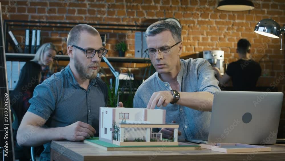 A group of people in the office working on the development of modern high-tech apartments