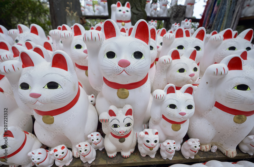 Maneki-neko lucky cats at Goutokuji Shrine, Tokyo, Japan