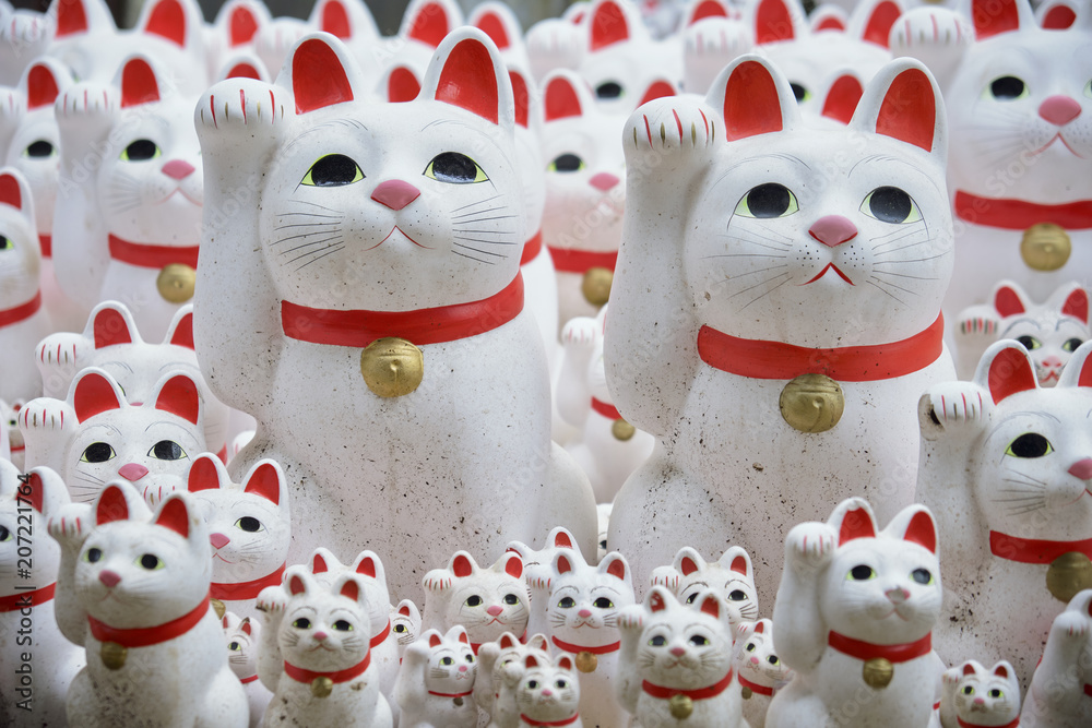 Maneki-neko lucky cats at Goutokuji Shrine, Tokyo, Japan