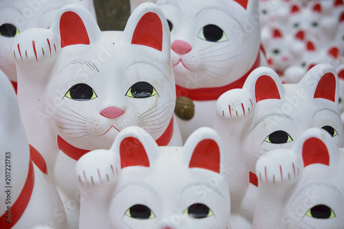 Maneki-neko lucky cats at Goutokuji Shrine, Tokyo, Japan photo