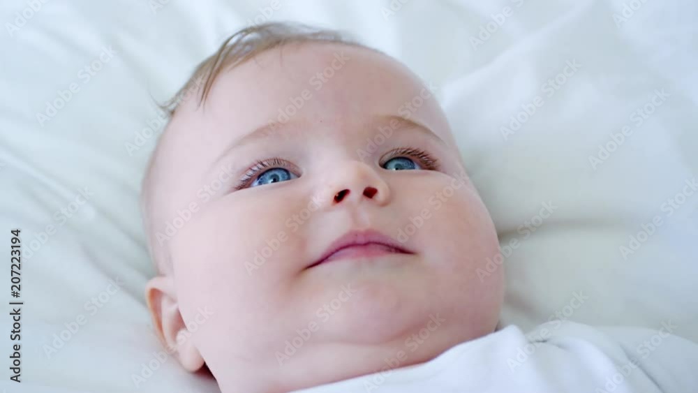 Overhead Shot Of Baby Boy Lying On Bed And Smiling Overhead Shot Of Baby Boy Lying On Bed And Smiling