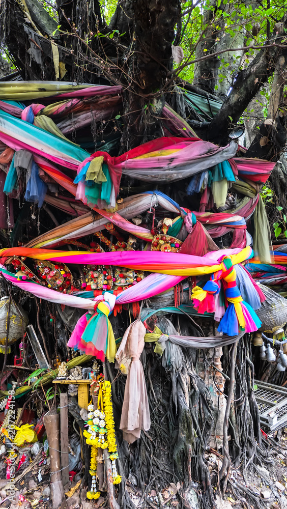 Thai spirit house at bodhi Tree with colorful garlands in Bangkok, May 28 2018