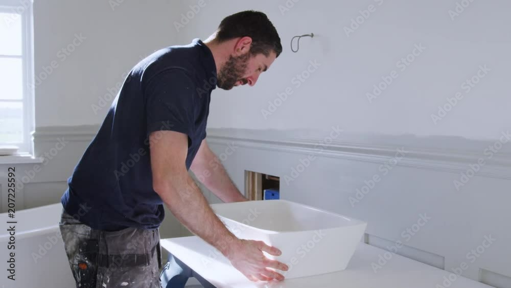 Plumber Fitting New Wash Basin In Bathroom
