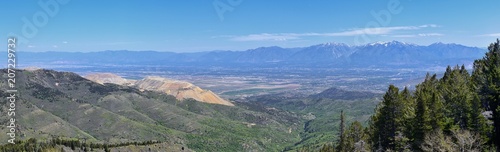 Panoramic view of Wasatch Front Rocky Mountains from the Oquirrh Mountains, by Kennecott Rio Tinto Copper mine, Utah Lake and Great Salt Lake Valley in early spring with melting snow and Cloudscape. U