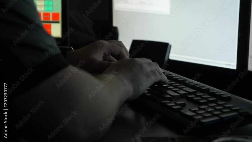 A 911 dispatcher works at his computer station at a control center to help respond to emergency calls.