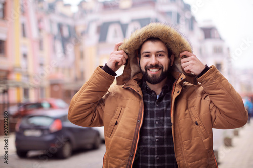 Handsome trendy hipster wal...
