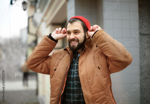 Handsome trendy hipster wal...
