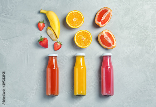 Flat lay composition with tasty juices and ingredients on light background