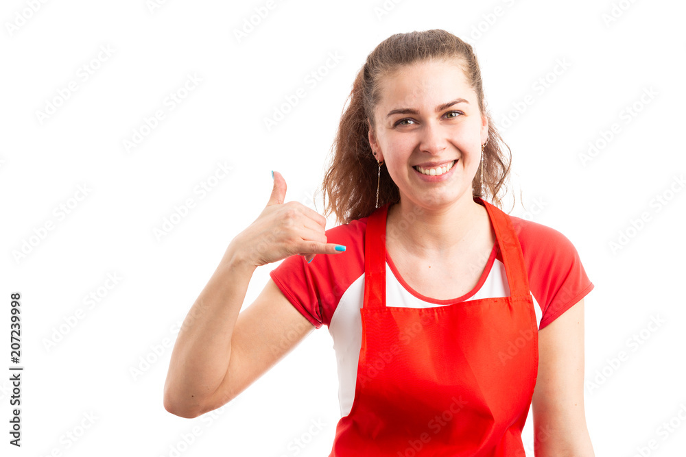 Female hypermarket or supermarket employee making call gesture. Female hypermarket or supermarket employee making call gesture.