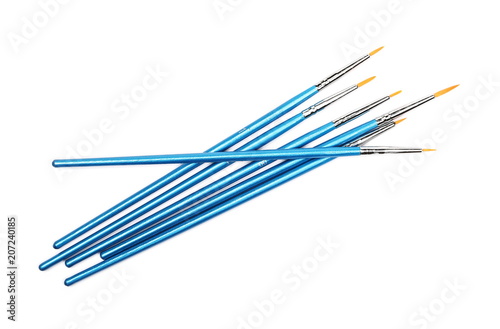 Blue paintbrushes isolated on white background, top view