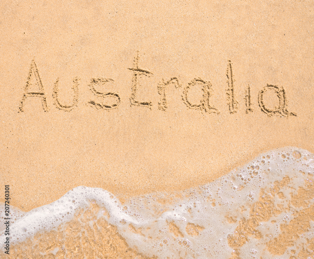 Fototapeta premium The word Australia written in the sand on beach