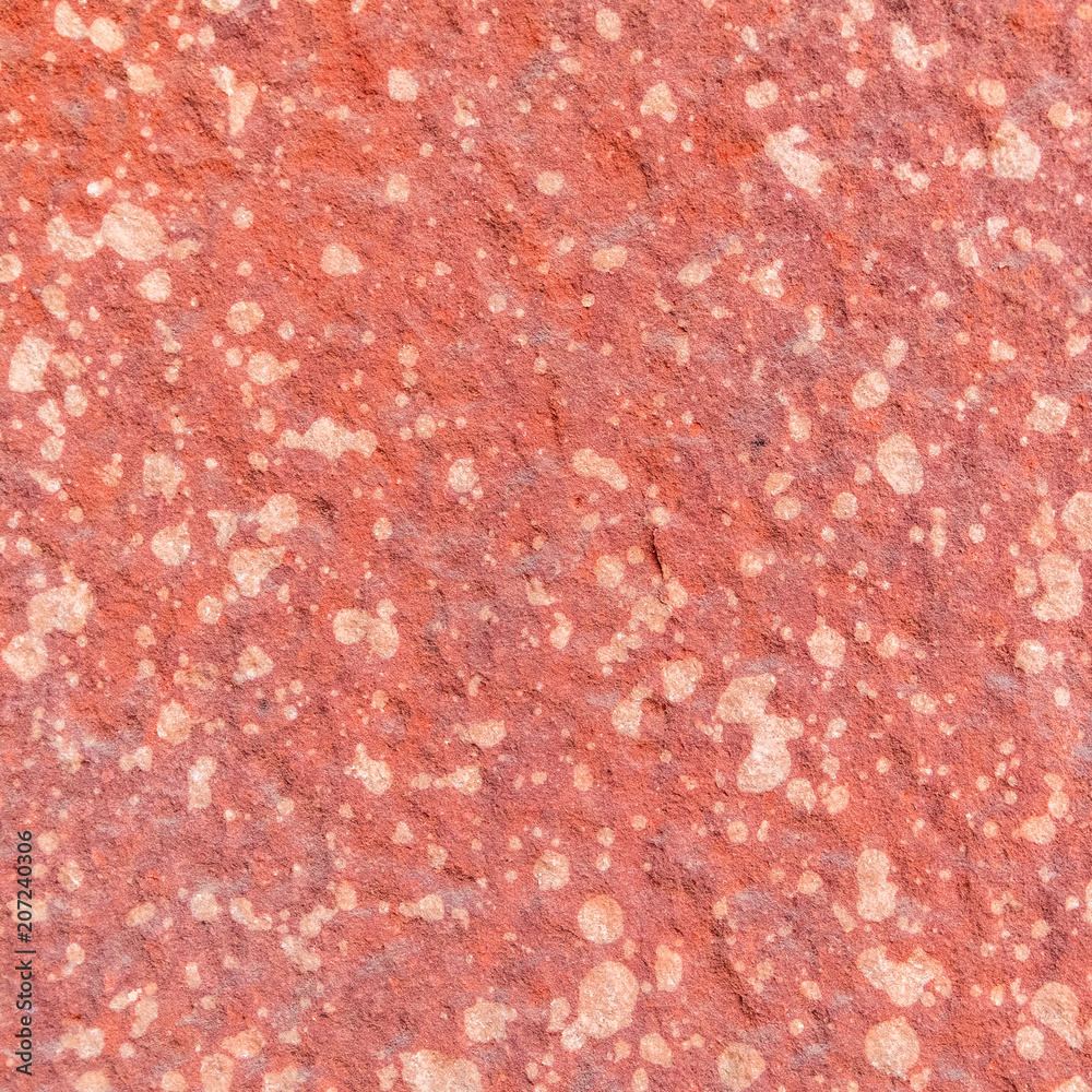 Red rough stone texture background. Material construction and architectural detail.