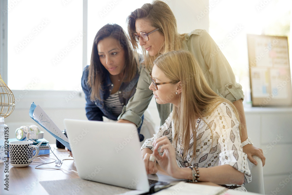 Startup businesswomen meeting in office and working on laptop Startup businesswomen meeting in office and working on laptop