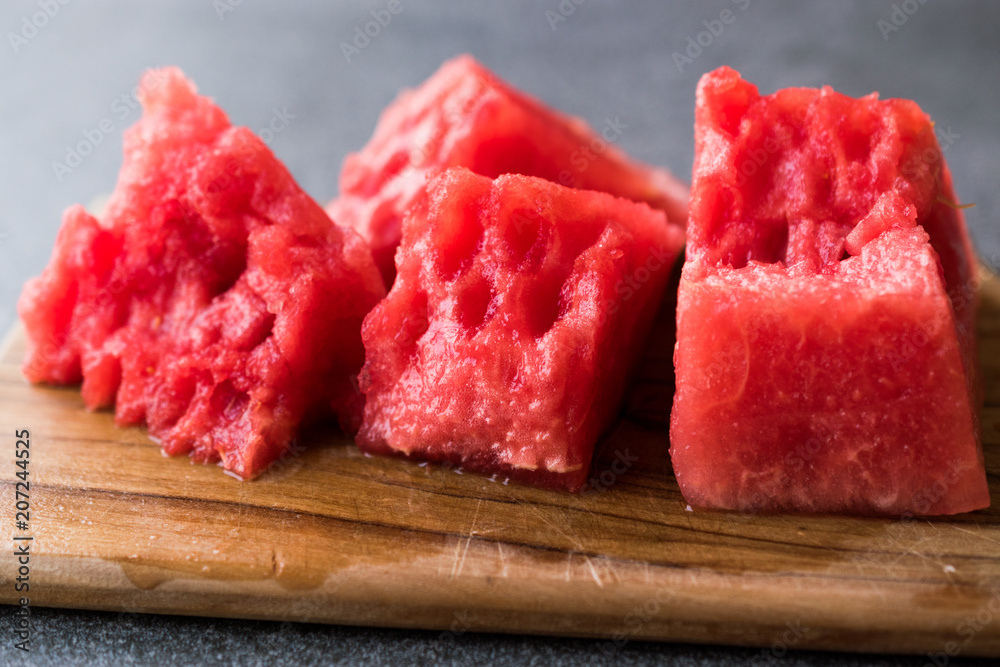 Seedless Watermelon Slices Ready to Eat on Wooden Surface.