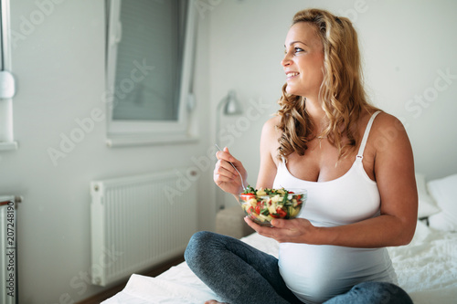 Portrait of pregnant woman eating healthy food