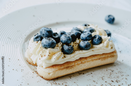 Nontraditional blueberry tiramisu with fresh berries. White background, copy space.