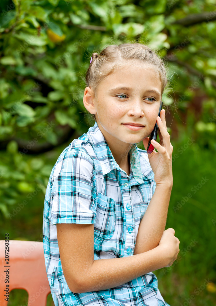 Fototapeta premium Young girl talking on mobile phone