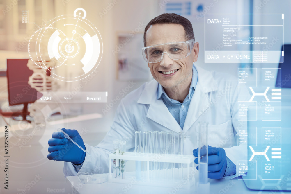 Happy scientist. Clever experienced enthusiastic scientist feeling optimistic and smiling while using a pipette for working with liquids