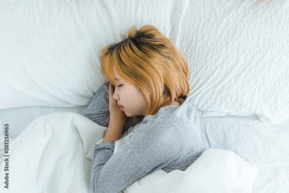 Beautiful young Asian woman sleeping in bed in the morning. Attractive asian girl use bedtime in her comfortable bedroom. Relaxation bedroom. Iifestyle asia woman at home concept. Beautiful young Asian woman sleeping in bed in the morning. Attractive asian girl use bedtime in her comfortable bedroom. Relaxation bedroom. Iifestyle asia woman at home concept.