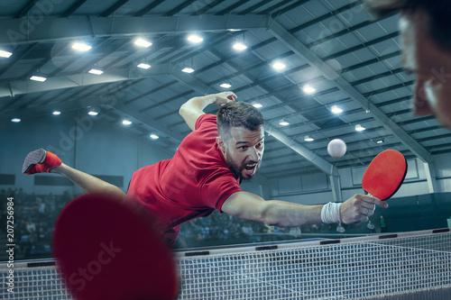 The table tennis player serving photo