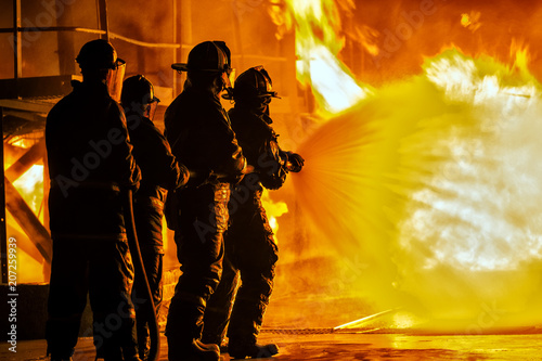 Photo JOHANNESBURG, SOUTH AFRICA - MAY, 2018 Firefighters spraying down fire during fi