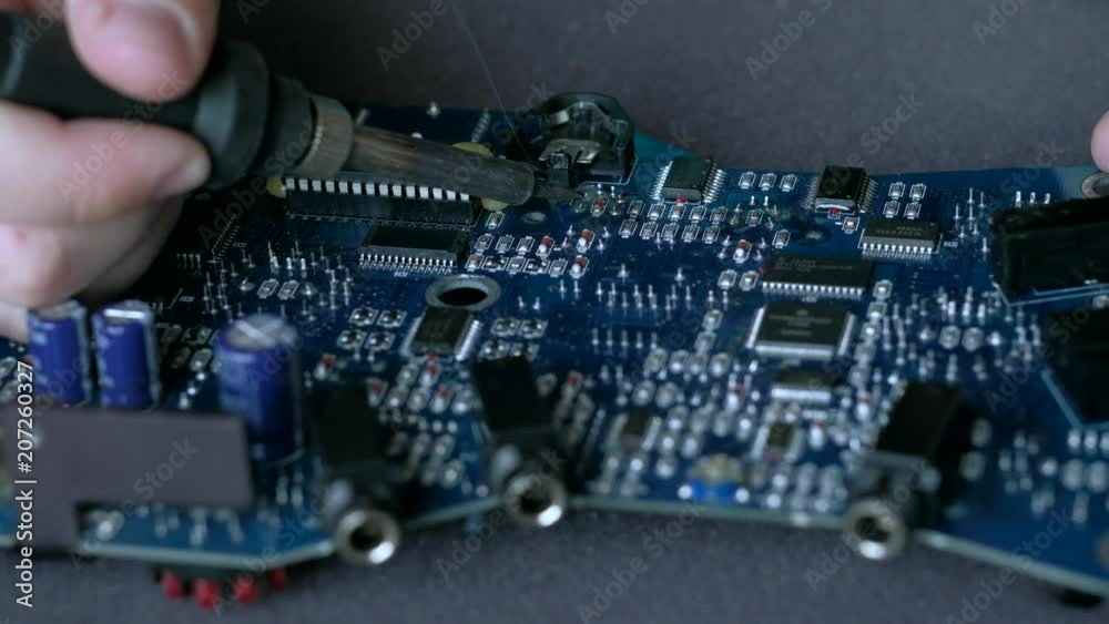Electrician makes repair of electronic circuit Board. Electrician makes repair of electronic circuit Board.