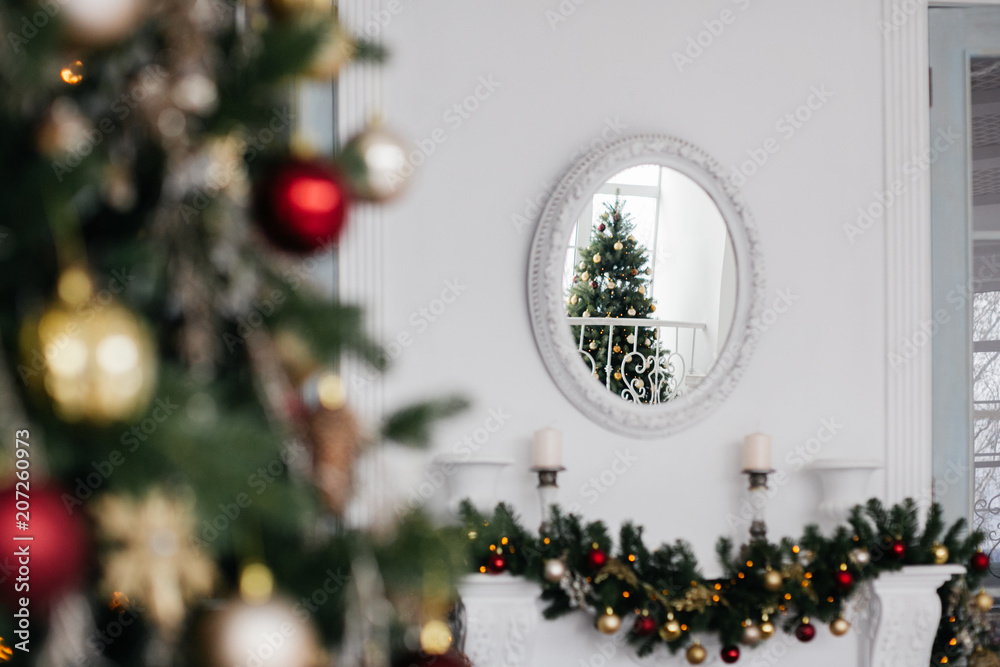 reflection in the mirror above the fireplace of the Christmas tree
