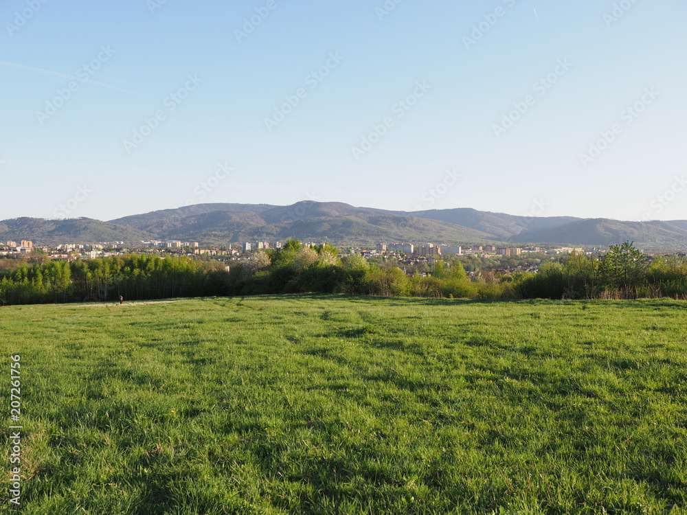 Wonderful panorama of cityscape european Bielsko-Biala city and countryside landscape of grassy field at Beskids, POLAND