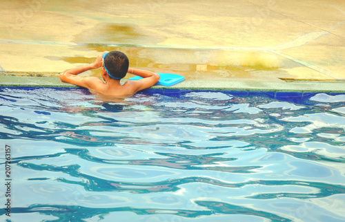 The boy stands by the edge of the pool, Rear view, Tired boy, Weak boy © singjai