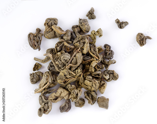Oolong tea To Guanine in round shape isolated. Green tea background. Dry Green Tea Leaves isolated on White Background