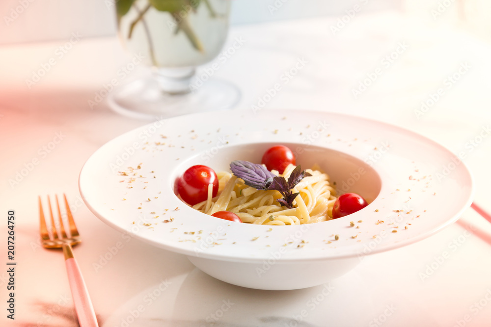 Spaghetti pasta with cherry tomatoes on white plate Spaghetti pasta with cherry tomatoes on white plate