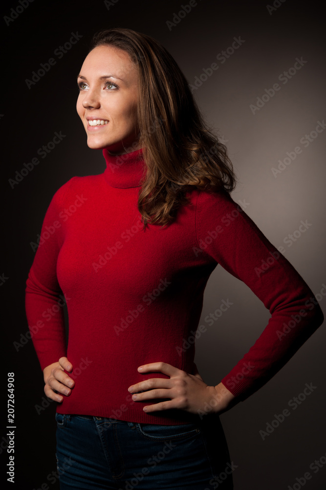 creaqtive portrait of a beautiful young caucasian happy woman in red wool kneeted sweater