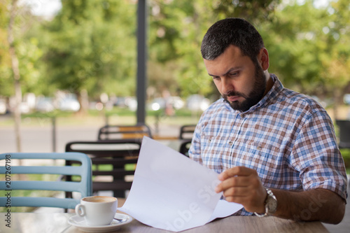 Worried man looking at papers