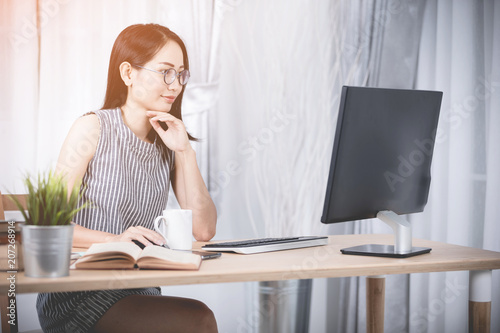 Young asian business woman working with compute .