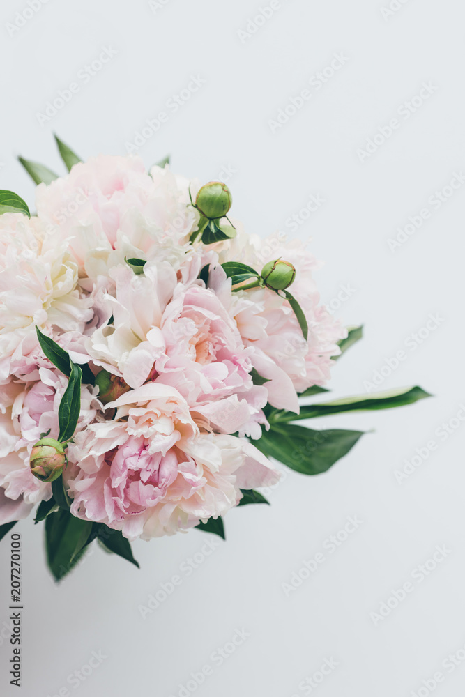 top view of light pink peony bouquet on white