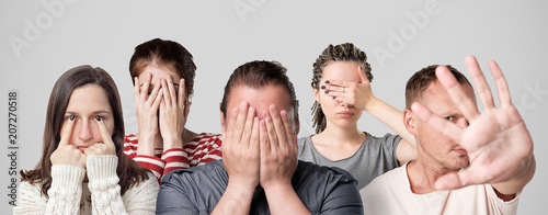 Concept of shame or guilt. Group of people closing their face or eyes with hands