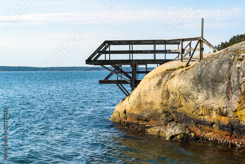 Outdoor wooden diving tower on a cliff by the sea. Hovik on the island Tjorn, Sweden.