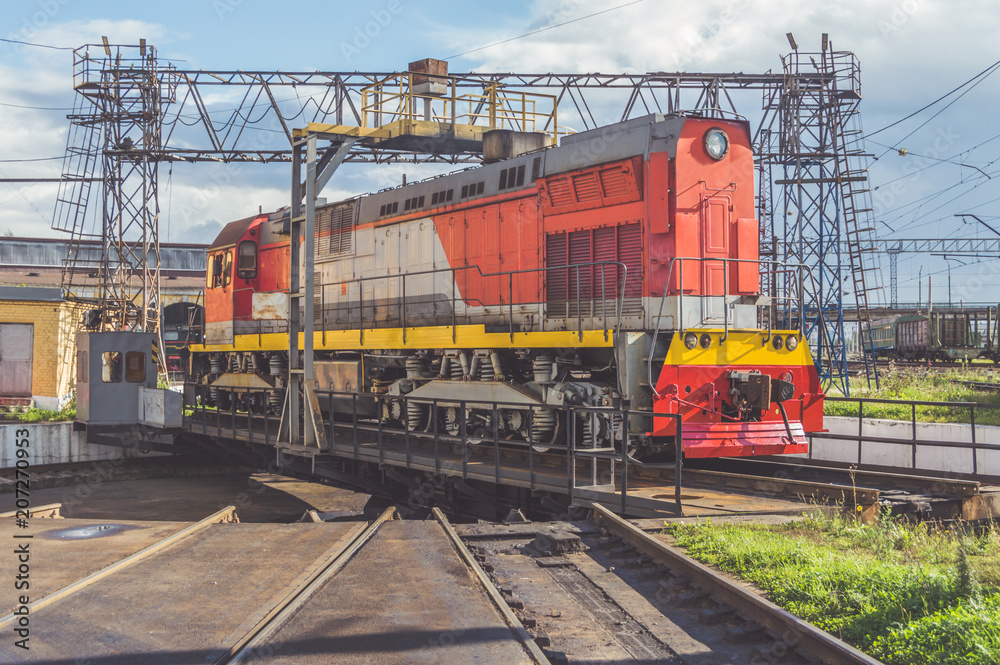 Sunny day, freight electric locomotive on a turntable with rails Sunny day, freight electric locomotive on a turntable with rails
