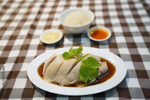 Steamed chicken with soy sauce, served with white rice also known as Hainanese Chicken Rice, Singapore food recipe, Popular in Thailand. 
