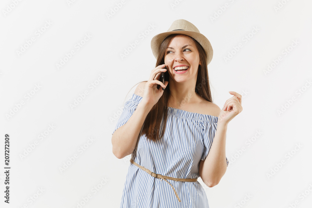 Smiling woman dressed blue dress, hat talking on mobile phone, conducting pleasant conversation isolated on white background. People, sincere emotions, lifestyle concept. Advertising area. Copy space. Smiling woman dressed blue dress, hat talking on mobile phone, conducting pleasant conversation isolated on white background. People, sincere emotions, lifestyle concept. Advertising area. Copy space.